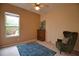 Bright bedroom with window, dresser, and comfortable armchair at 4940 Thames Ln, Sarasota, FL 34238