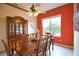 Dining room with wood table, china cabinet, and accent wall at 4940 Thames Ln, Sarasota, FL 34238