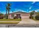 One-story home with pink exterior, two-car garage, and lush landscaping at 4940 Thames Ln, Sarasota, FL 34238