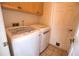 Laundry room with washer and dryer and built-in cabinets at 4940 Thames Ln, Sarasota, FL 34238