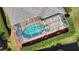 Aerial view of kidney-shaped pool and spa with screened enclosure at 4940 Thames Ln, Sarasota, FL 34238