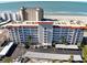 Aerial view of a beachfront condominium building with ocean views and parking at 500 The Esplanade N # 306, Venice, FL 34285