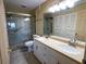 Primary bathroom with double sinks, shower, and linen closet at 500 The Esplanade N # 306, Venice, FL 34285
