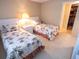 Second bedroom with two twin beds and access to a hallway at 500 The Esplanade N # 306, Venice, FL 34285