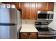 Stainless steel appliances and wood cabinets in the kitchen at 500 The Esplanade N # 306, Venice, FL 34285
