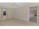 Well-lit bedroom with ceiling fan and access to hallway at 519 Rubens Dr # 519, Nokomis, FL 34275