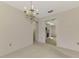 Simple dining area with chandelier and access to kitchen at 519 Rubens Dr # 519, Nokomis, FL 34275