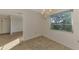 Bright dining room with chandelier and view to kitchen at 519 Rubens Dr # 519, Nokomis, FL 34275