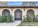 Front entrance with arched entryway and screen door at 519 Rubens Dr # 519, Nokomis, FL 34275