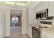 Kitchen with stainless steel appliances and view to living room at 519 Rubens Dr # 519, Nokomis, FL 34275