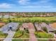 Bird's-eye view of upscale community, showcasing manicured lawns and golf course at 5561 White Ibis Dr, North Port, FL 34287