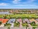 High-angle view of a single Gathering home with a golf course in the background at 5561 White Ibis Dr, North Port, FL 34287