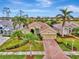 Luxury home with brick paver driveway and lush landscaping at 5561 White Ibis Dr, North Port, FL 34287