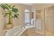 Spa-like bathroom with corner bathtub and walk-in shower at 5561 White Ibis Dr, North Port, FL 34287
