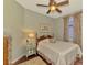 Cozy bedroom with a queen-size bed and floral curtains at 5561 White Ibis Dr, North Port, FL 34287