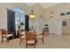 Formal dining room with a glass-top table and four chairs at 5561 White Ibis Dr, North Port, FL 34287