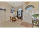 Bright dining room with glass-top table and four chairs, located near the entryway at 5561 White Ibis Dr, North Port, FL 34287
