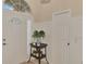 Bright entryway with white door, wainscoting and decorative vase at 5561 White Ibis Dr, North Port, FL 34287