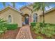 Front entry with a blue door, walkway, and landscaping at 5561 White Ibis Dr, North Port, FL 34287