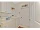 Bright laundry room with washer, dryer, and ample cabinet space at 5561 White Ibis Dr, North Port, FL 34287