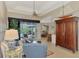 Living room with comfortable seating and views to the pool and lanai at 5561 White Ibis Dr, North Port, FL 34287