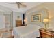 Main bedroom with ensuite bathroom and hardwood floors at 5561 White Ibis Dr, North Port, FL 34287
