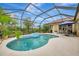 Inviting kidney-shaped pool with a spa and screened enclosure at 5561 White Ibis Dr, North Port, FL 34287