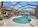 Relaxing kidney-shaped pool with spa and screened enclosure at 5561 White Ibis Dr, North Port, FL 34287