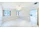 Bright bedroom with carpet flooring, windows and door to another room at 6246 Green View Cir # 97, Sarasota, FL 34231