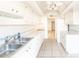 White kitchen with vaulted ceiling and breakfast bar at 6246 Green View Cir # 97, Sarasota, FL 34231