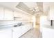 White kitchen with vaulted ceiling and appliances at 6246 Green View Cir # 97, Sarasota, FL 34231