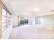Spacious living room with carpet, large windows and sliding doors to patio at 6246 Green View Cir # 97, Sarasota, FL 34231