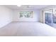 Bright and airy living room with carpet, large windows and sliding glass doors at 6246 Green View Cir # 97, Sarasota, FL 34231