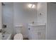 Clean bathroom with white vanity and marble tile at 6670 Harmony Rd, North Port, FL 34287