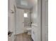 Updated bathroom with marble tile and white vanity at 6670 Harmony Rd, North Port, FL 34287