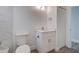 Clean bathroom with white vanity and marble tile at 6670 Harmony Rd, North Port, FL 34287