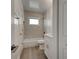 Renovated bathroom, featuring marble tile and a white vanity at 6670 Harmony Rd, North Port, FL 34287