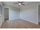 Spacious bedroom with ceiling fan and wood-look floors at 6670 Harmony Rd, North Port, FL 34287