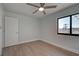 Bright bedroom featuring a ceiling fan and wood-look flooring at 6670 Harmony Rd, North Port, FL 34287