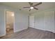 Bedroom with ensuite bathroom and wood-look floors at 6670 Harmony Rd, North Port, FL 34287