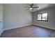 Bright bedroom with ceiling fan and wood-look floors at 6670 Harmony Rd, North Port, FL 34287