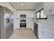 Bright kitchen featuring stainless steel appliances and white cabinetry at 6670 Harmony Rd, North Port, FL 34287