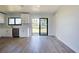Modern kitchen with white cabinets, stainless steel appliances, and wood-look floors at 6670 Harmony Rd, North Port, FL 34287