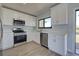 Modern kitchen with white cabinets, stainless steel appliances, and quartz countertops at 6670 Harmony Rd, North Port, FL 34287