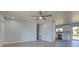 Open concept living room with kitchen access and sliding glass doors at 6670 Harmony Rd, North Port, FL 34287
