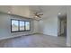 Living room with light walls, wood-look floors, and a view to the hallway at 6670 Harmony Rd, North Port, FL 34287