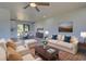 Bright living room with light walls, wood-look floors, and stylish furniture at 6670 Harmony Rd, North Port, FL 34287