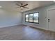 Living room with light walls, wood-look floors, and large window at 6670 Harmony Rd, North Port, FL 34287