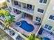 Aerial view of a condo building with multiple pools and patio areas at 702 Granada Ave # 7, Venice, FL 34285