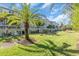 Landscaped backyard with green grass and a row of condo buildings at 702 Granada Ave # 7, Venice, FL 34285